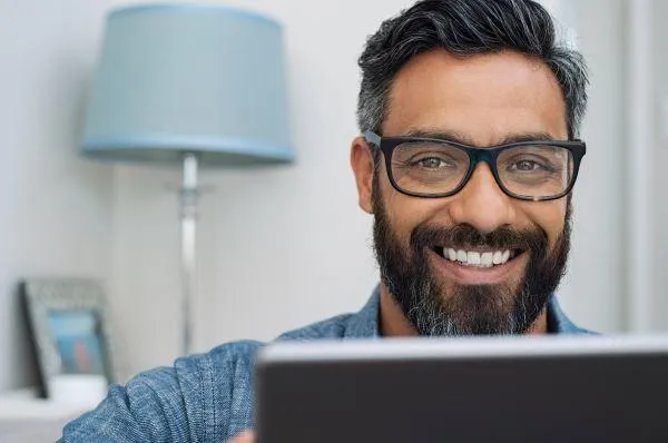 man with laptop smiling