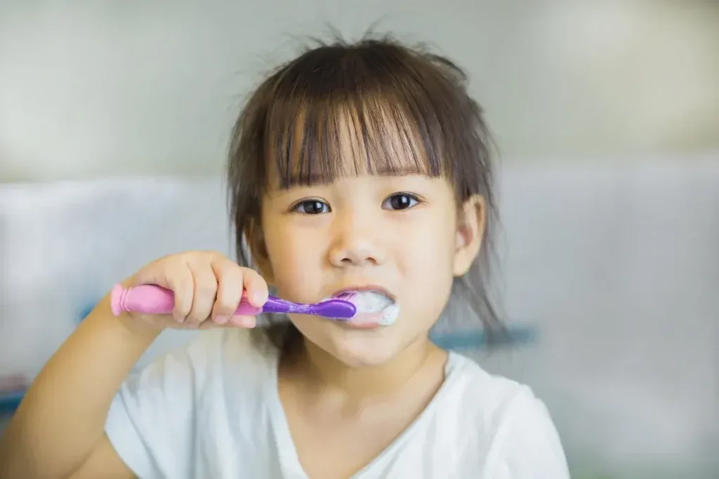 Little kids brushing teeth by herself as activity daily living. Dental care hygien for tooth & gums health.