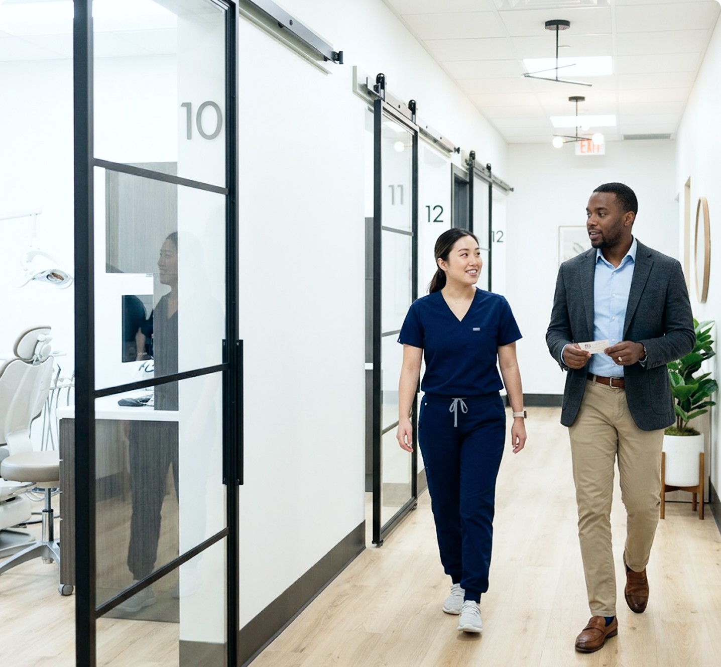 Aqua Dentistry team member walking with a patient down the office hallway