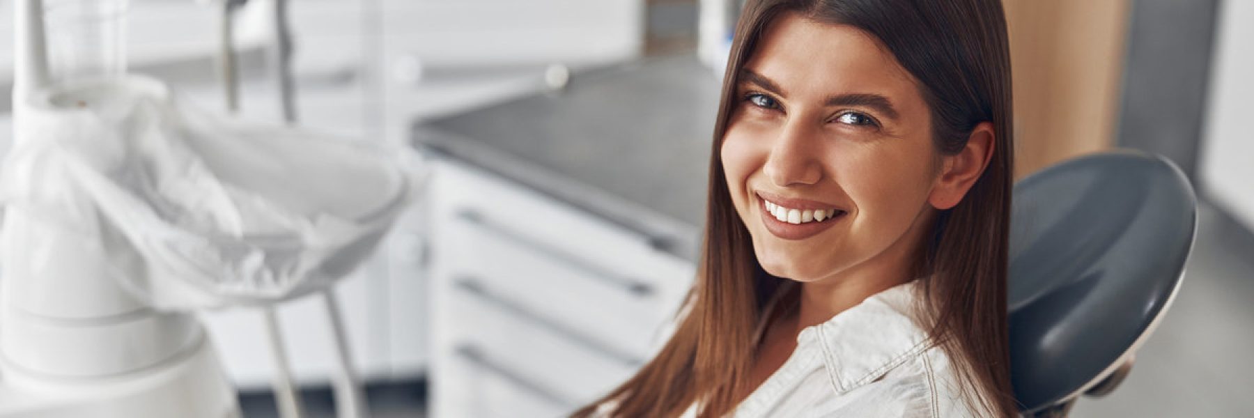 Happy caucasian woman at dentist cabinet